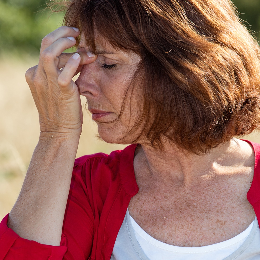 woman pinching the bridge of her nose