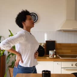 Woman with acid reflux holds stomach