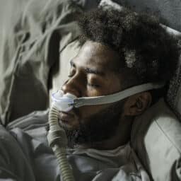 Man with CPAP over his nose while sleeping