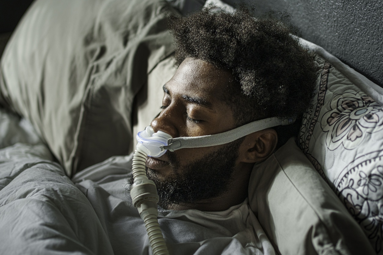 Man with CPAP over his nose while sleeping