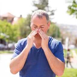 Man massaging his sinuses with his hands.