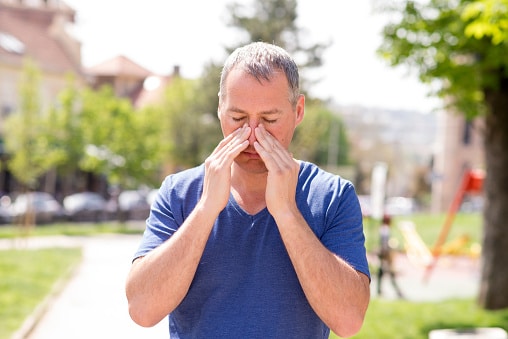 Man massaging his sinuses with his hands.